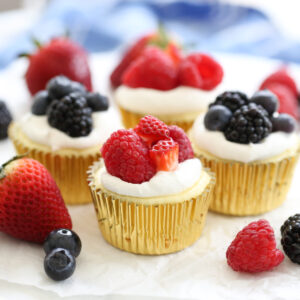 fruit topped mini cheesecakes on a platter