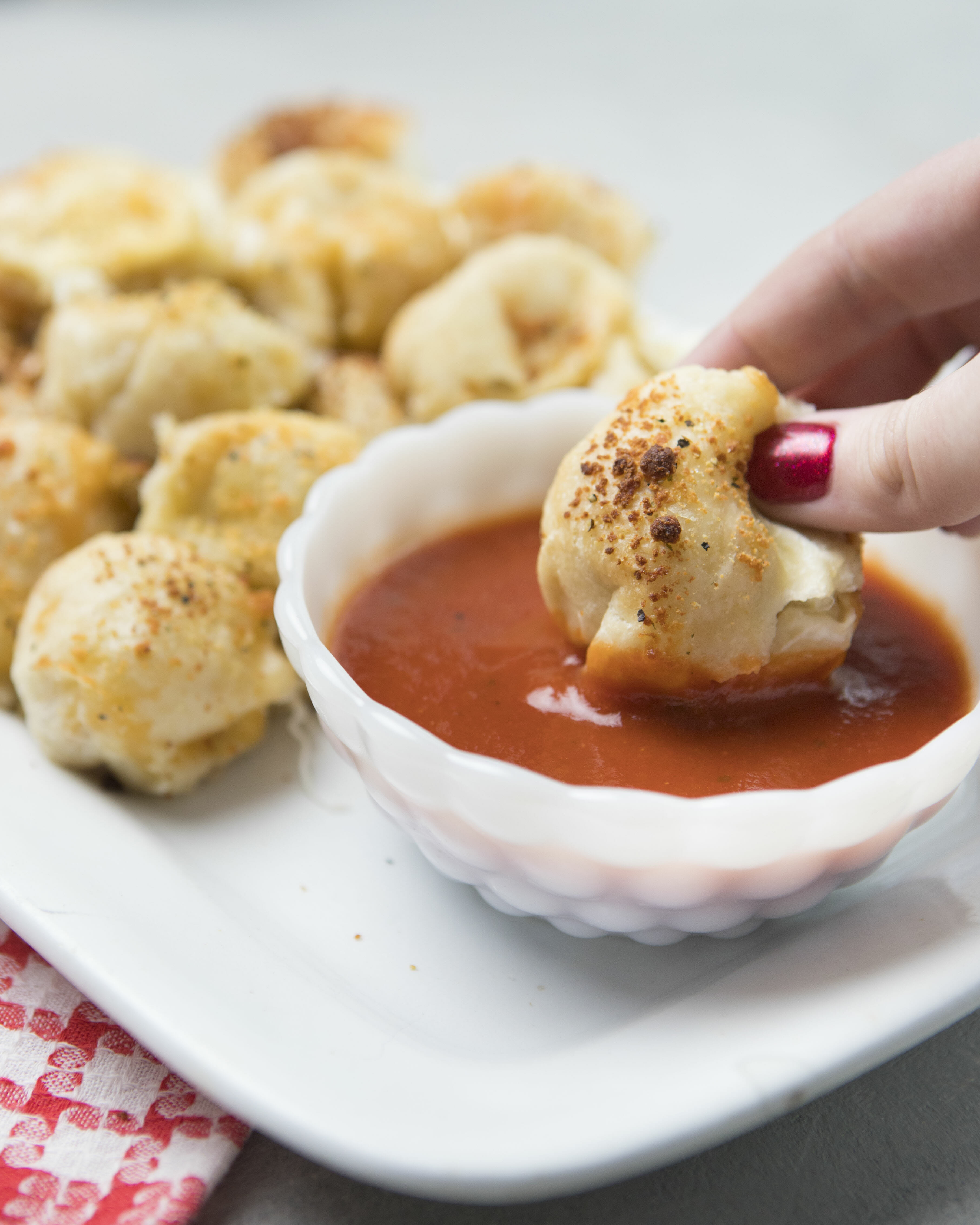 dunking pizza roll in marinara