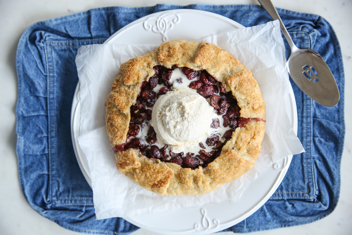 galette with ice cream on a white tray and denim place mat
