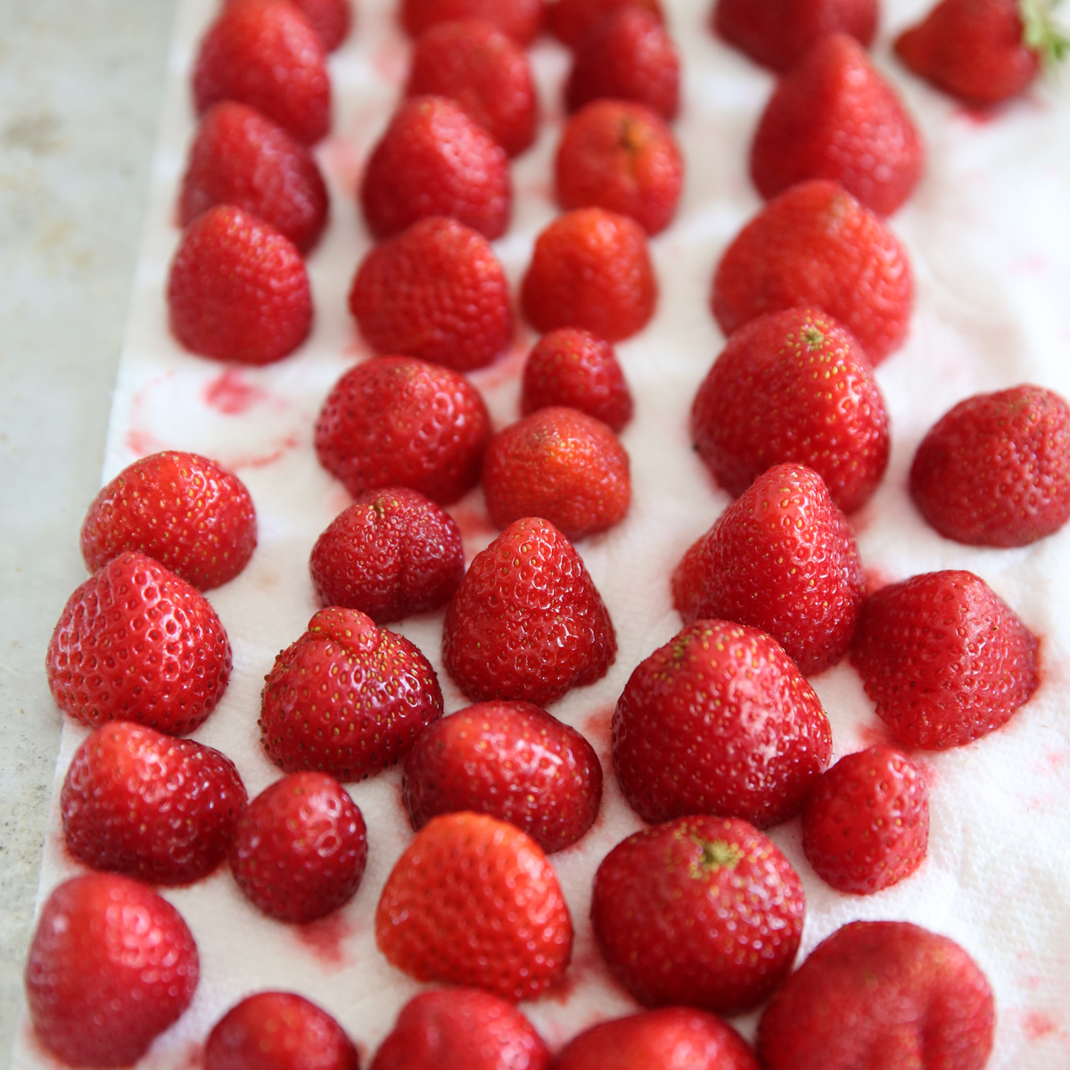 cut strawberries on a paper towel