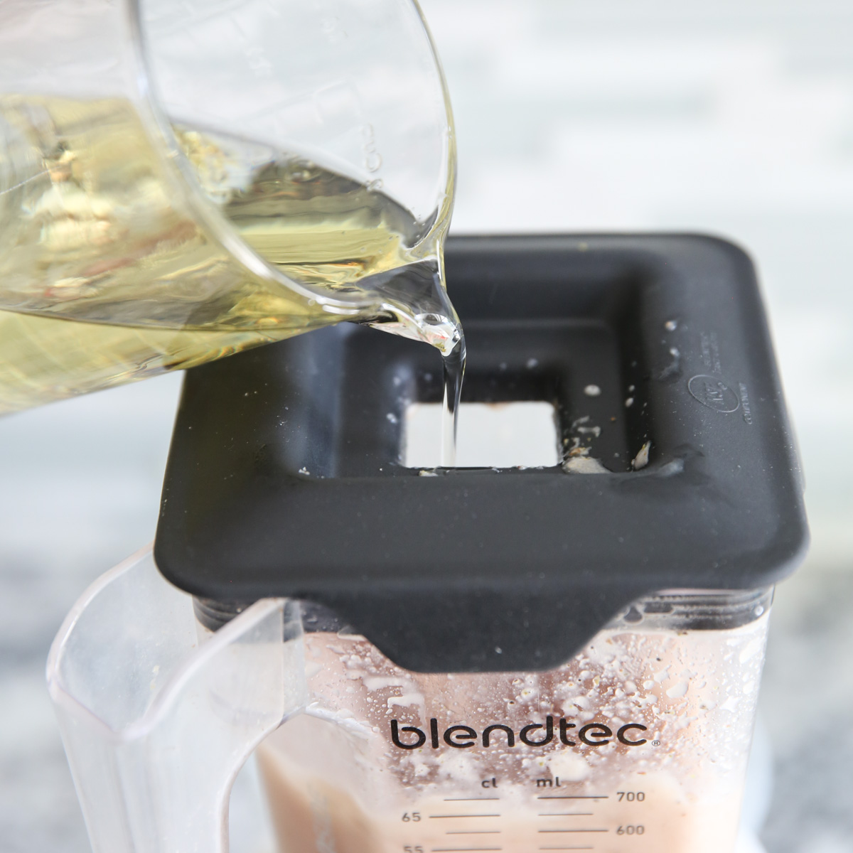 pouring oil into blender