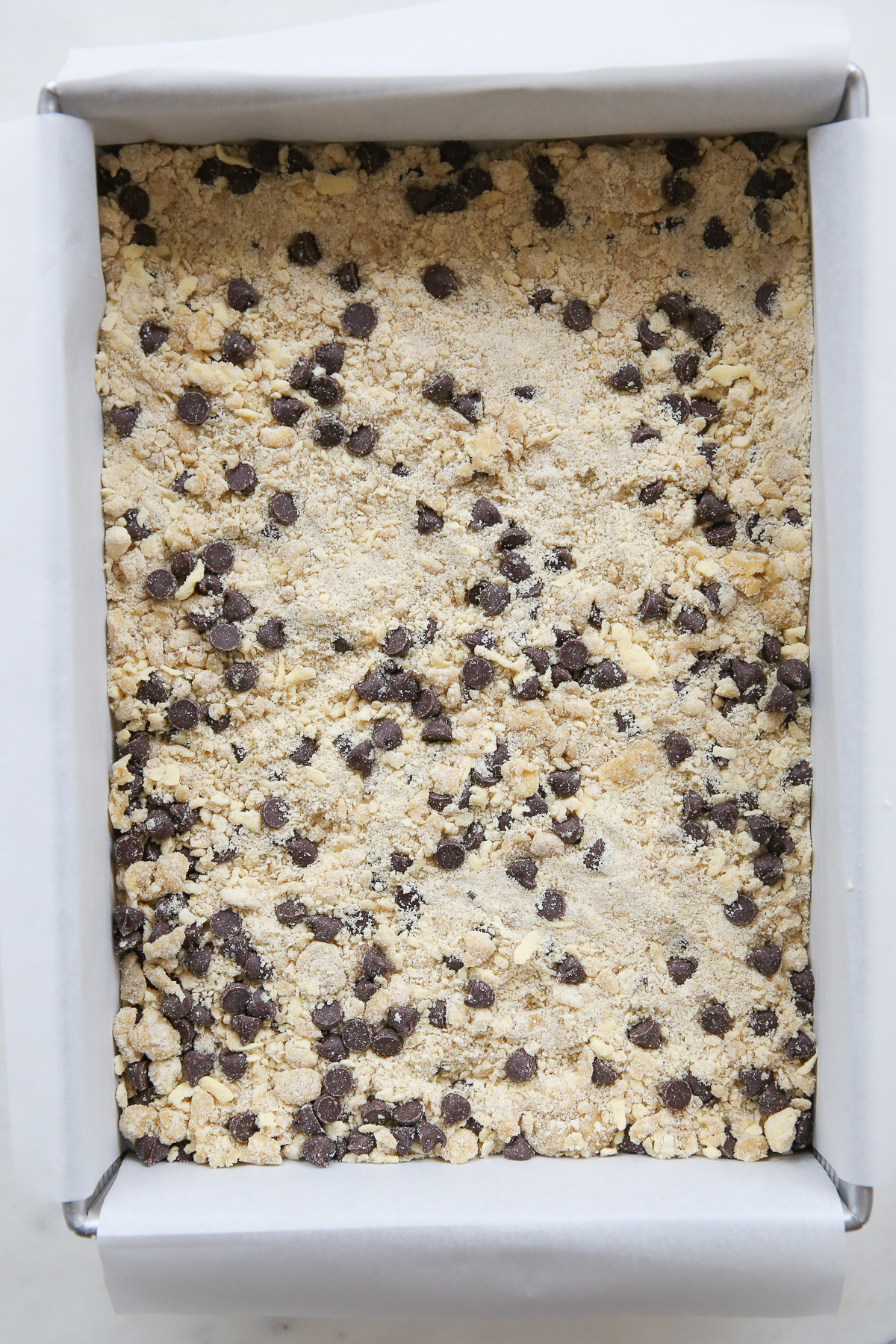 cookie crumble dough pressed into baking pan