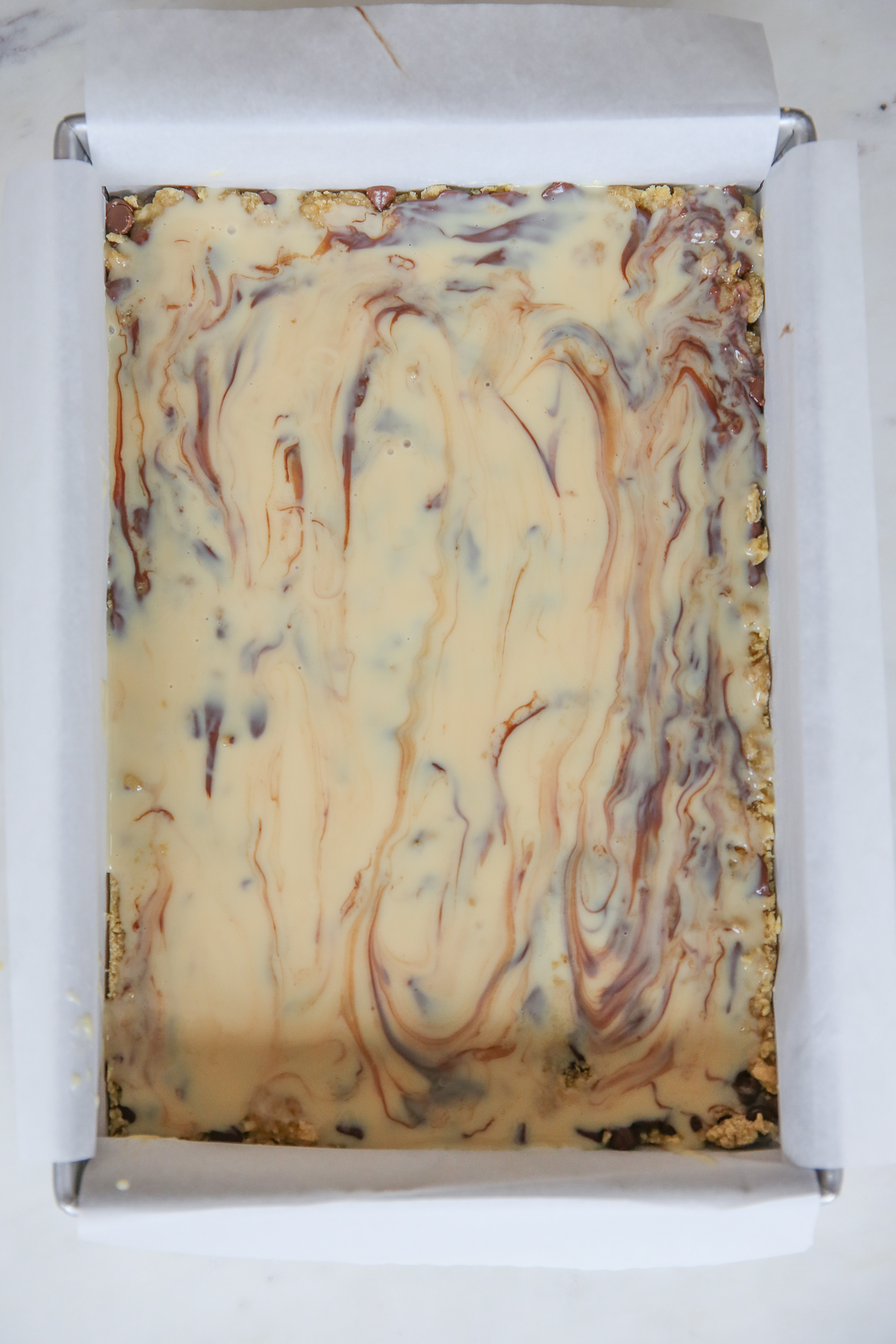 spread and smoothed condensed milk on cookie bars