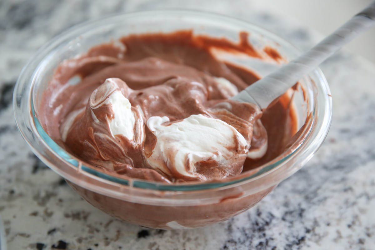 mixing whipped cream and chocolate pudding