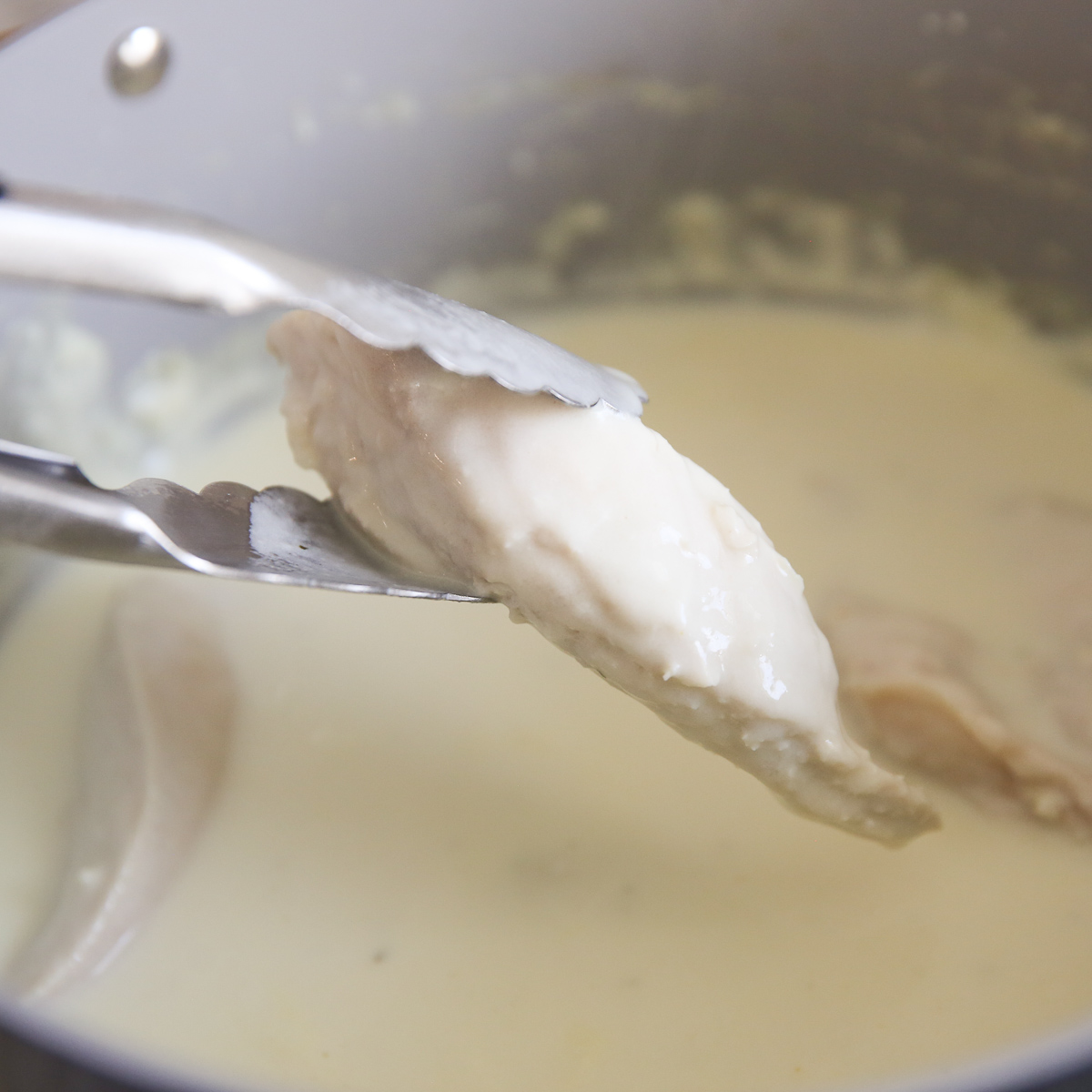 poaching chicken in a creamy sauce