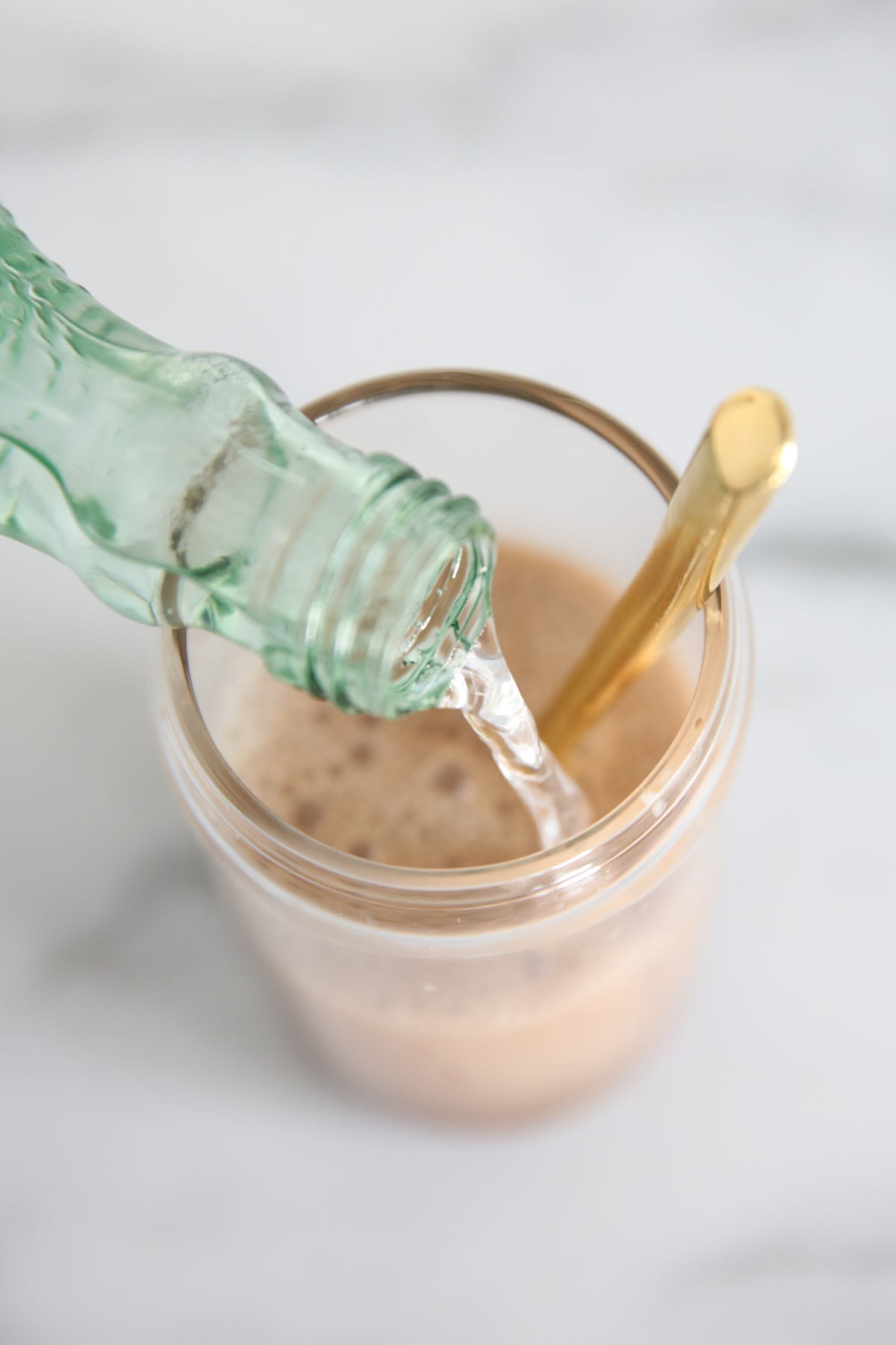 sparkling water pouring into chocolate soda