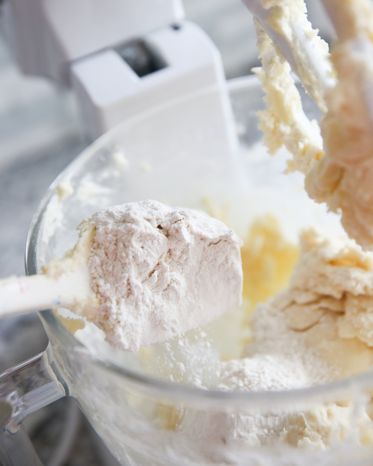 adding flour to sugar cookie dough in kitchenaid