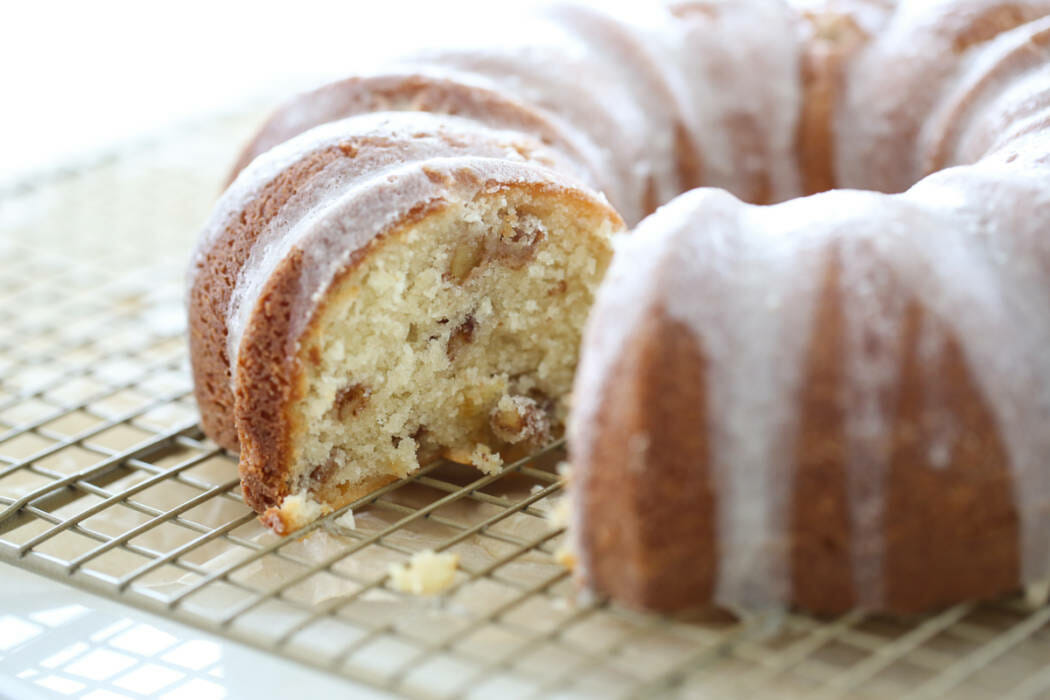 A finished bundt cake with a slice out of it.