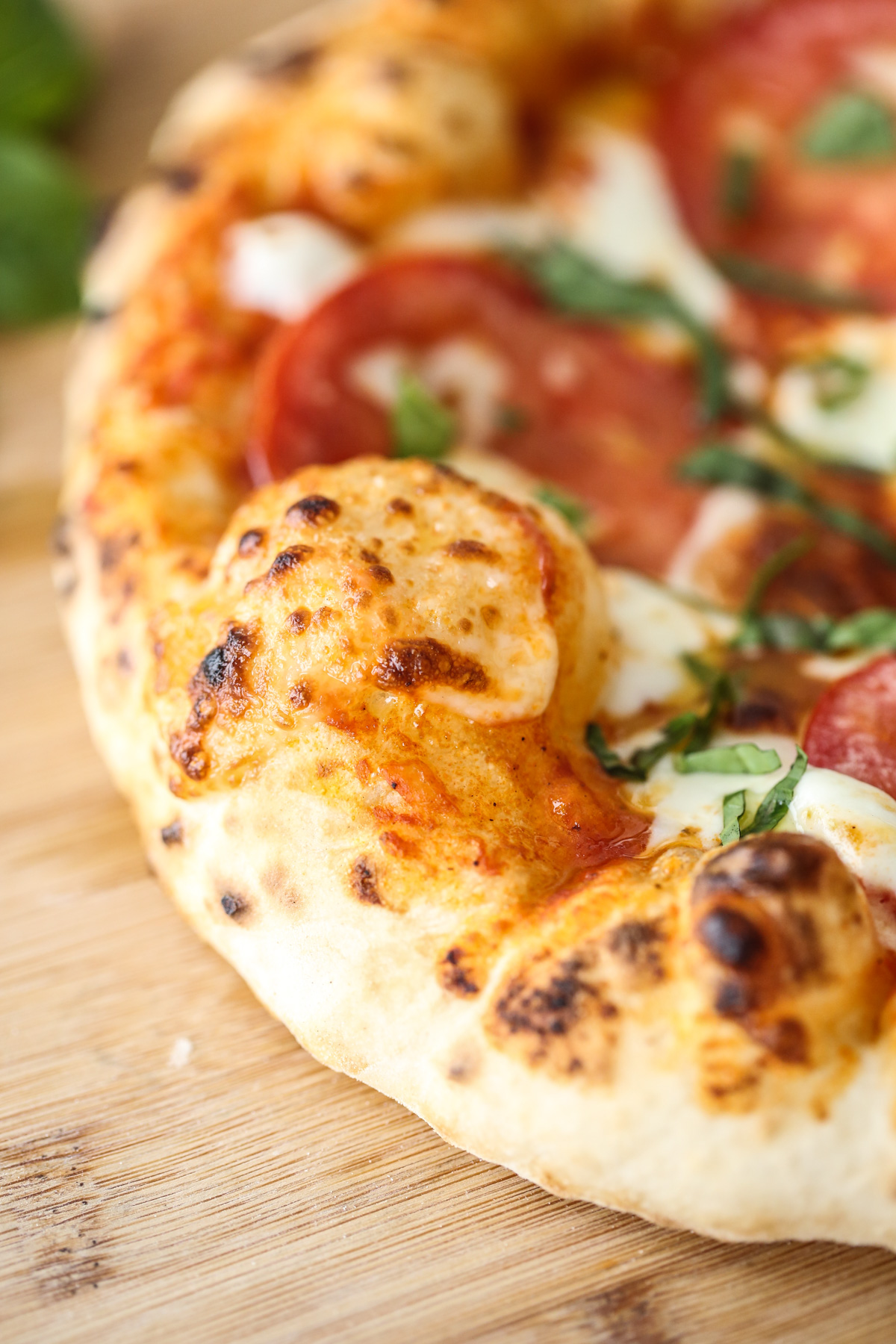 close up of baked pizza with bubbly crust