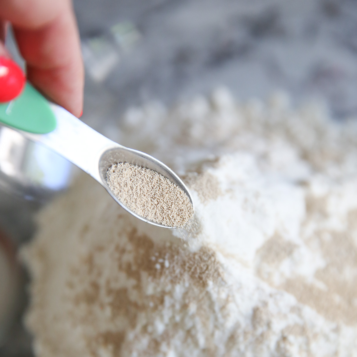 adding yeast to pizza dough