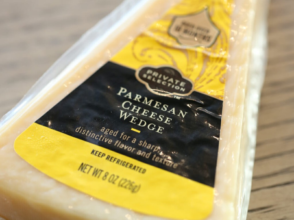 A wedge of Parmesan cheese in its wrapper.