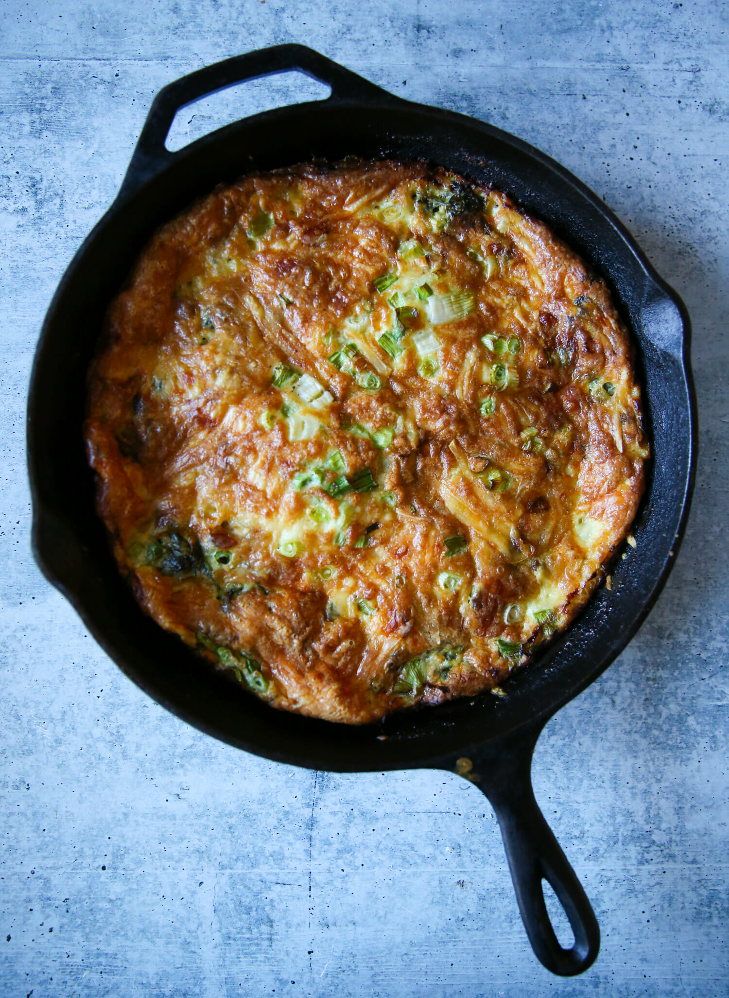spinach and bacon frittata in a cast iron pan from our best bites