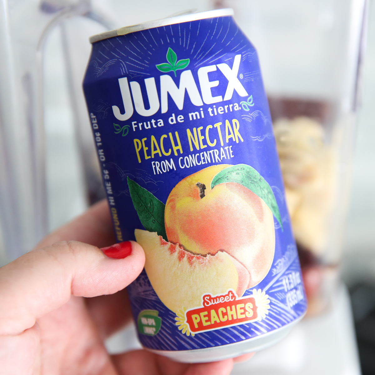 fruit nectar in a can being held