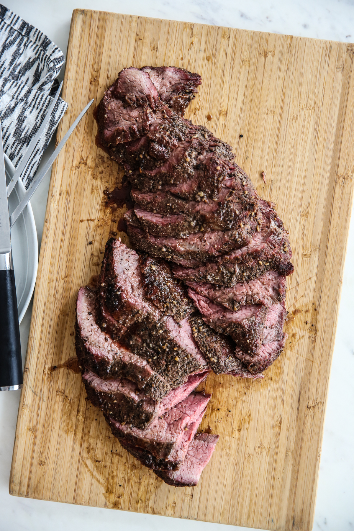 Smoked Tri Tip Roast on a cutting board, sliced