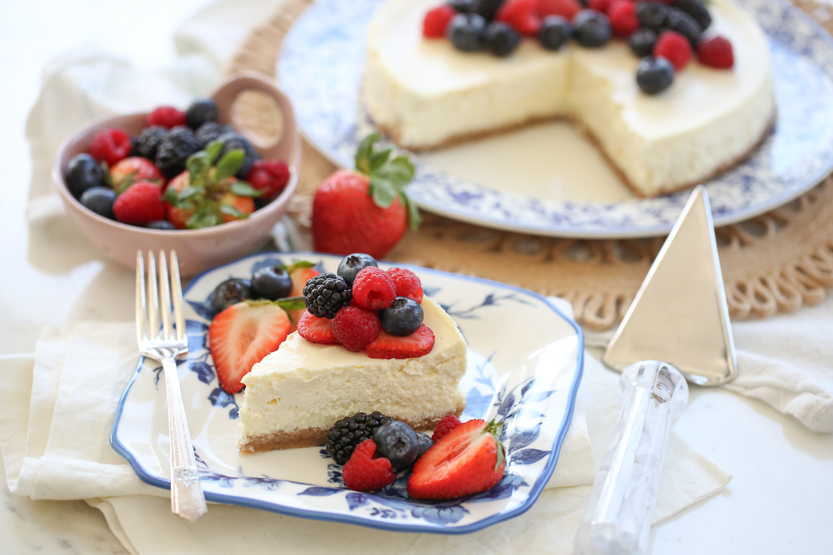 slice of cheesecake on a plate with fresh berries